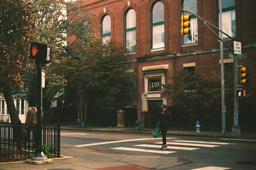 Woman walking briskly across a downtown crosswalk
